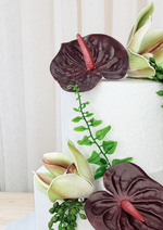 Artificial wedding cake flower close-up with burgundy faux anthuriums, green-and-burgundy orchids and trailing green leaves. For birthday, event and celebration cakes. Made in Melbourne by Flowers For Ever After, shipping Australia and Worldwide.