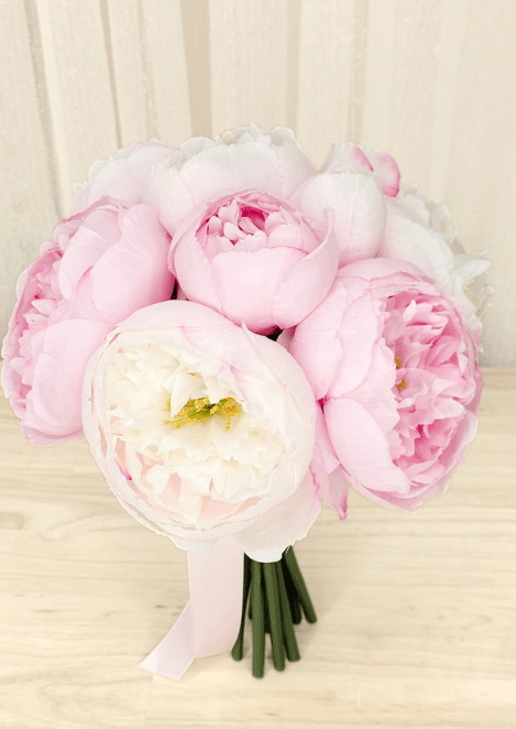 Artificial wedding small bouquet, angled view of pink and ivory faux peonies with pale pink ribbon wrapping. Made in Melbourne by Flowers For Ever After, shipping Australia and Worldwide.