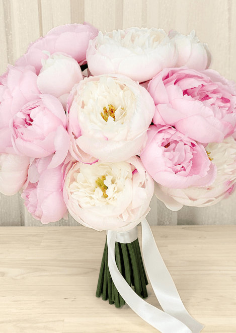 Artificial wedding rounded bouquet with pink and ivory faux peonies, golden flower centres and white ribbon tails. Made in Melbourne by Flowers For Ever After, shipping Australia and Worldwide.