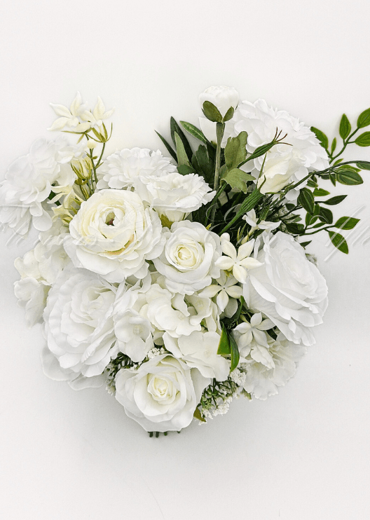 Artificial wedding bridal bouquet, top view of white faux roses, round white blooms and small white flowers with green leaves. Made in Melbourne by Flowers For Ever After, shipping Australia and Worldwide.