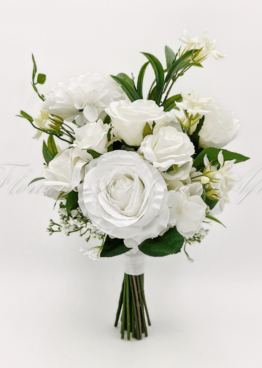 Artificial wedding bridesmaid bouquet, angled view of white faux roses, round white blooms, small white flowers and green leaves. Made in Melbourne by Flowers For Ever After, shipping Australia and Worldwide.