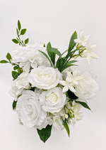 Artificial wedding bridesmaid bouquet, top view of white faux roses, round white blooms and small white flowers among green leaves. Made in Melbourne by Flowers For Ever After, shipping Australia and Worldwide.