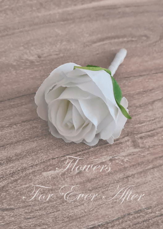 Artificial wedding boutonniere, side view of a white faux rose with a smaller dusty pink rose, pale berries and delicate green foliage. For formals, proms and ball occasions. Made in Melbourne by Flowers For Ever After, shipping Australia and Worldwide.