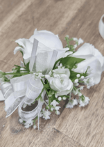 Artificial wedding corsage, side view of a white faux rose with dusty pink rosebuds, pale berry sprigs and ivory ribbons. For formals, proms and ball occasions. Made in Melbourne by Flowers For Ever After, shipping Australia and Worldwide.