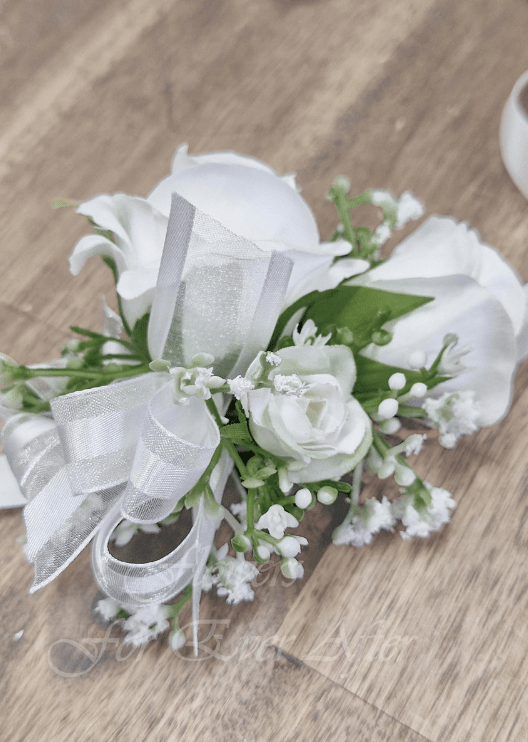 Artificial wedding corsage, side view of a white faux rose with dusty pink rosebuds, pale berry sprigs and ivory ribbons. For formals, proms and ball occasions. Made in Melbourne by Flowers For Ever After, shipping Australia and Worldwide.