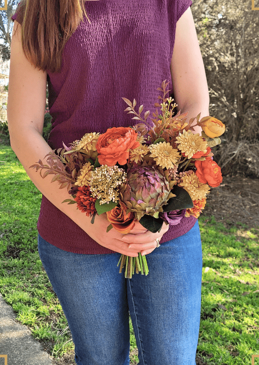 Artificial wedding bridal bouquet, handheld side view of orange, yellow and burgundy faux flowers with green leaves. Made in Melbourne by Flowers For Ever After, shipping Australia and Worldwide.