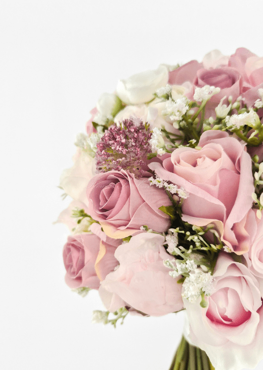 Artificial wedding bouquet close-up with dusty pink faux roses, blush peony petals, mauve flower head and tiny white sprigs. Made in Melbourne by Flowers For Ever After, shipping Australia and Worldwide.