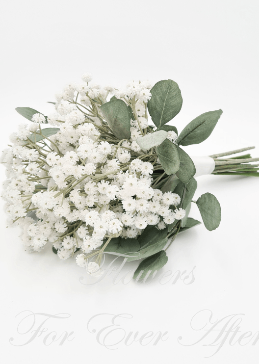 Artificial wedding bridesmaid posy, angled view of white faux baby's breath, grey-green leaves and ribbon-wrapped stems. Made in Melbourne by Flowers For Ever After, shipping Australia and Worldwide.