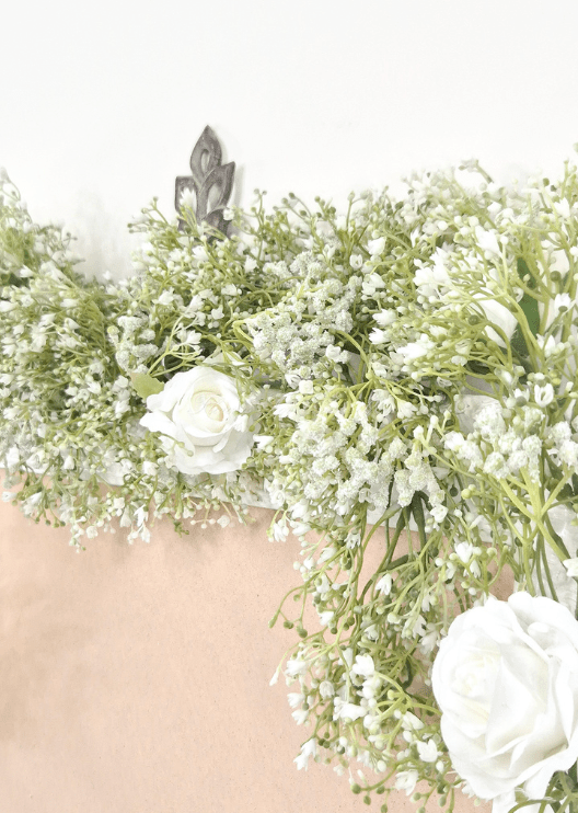Artificial wedding garland close-up with tiny white faux baby's breath flowers and white roses. Made in Melbourne by Flowers For Ever After, shipping Australia and Worldwide.