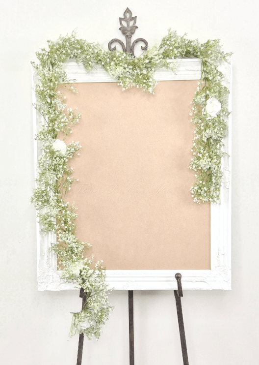 Artificial wedding sign garland with white faux baby's breath and white roses trailing down both frame sides. Made in Melbourne by Flowers For Ever After, shipping Australia and Worldwide.