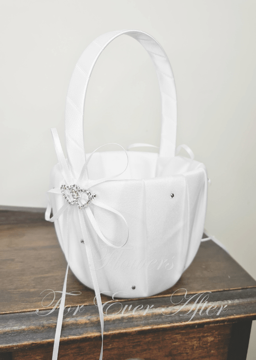 Artificial wedding flower and faux petal basket in white fabric with ribbon-wrapped handle, white bow, twin-heart jewel accent and small gems. Made in Melbourne by Flowers For Ever After, shipping Australia and Worldwide.