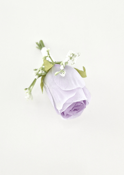 Artificial wedding boutonniere, overhead view of a lilac faux rosebud with tiny white flowers and green sepals. For formals, proms and ball occasions. Made in Melbourne by Flowers For Ever After, shipping Australia and Worldwide.