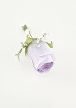 Artificial wedding boutonniere, overhead view of a lilac faux rosebud with tiny white flowers and green sepals. For formals, proms and ball occasions. Made in Melbourne by Flowers For Ever After, shipping Australia and Worldwide.