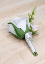 Artificial wedding boutonniere, side view of a white faux rose, pale blush rosebud and ivory ribbon-wrapped stems. For formals, proms and ball occasions. Made in Melbourne by Flowers For Ever After, shipping Australia and Worldwide.