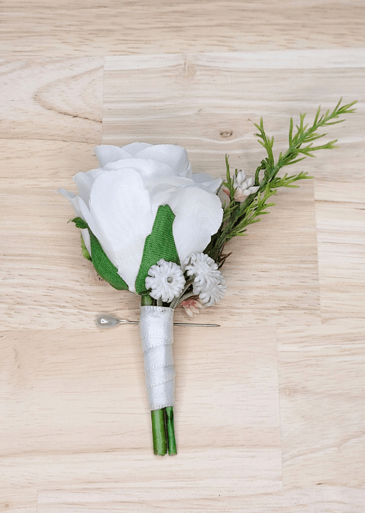 Artificial wedding boutonniere with a white faux rose, tiny white flowers, a slender green sprig and ivory-wrapped stems. For formals, proms and ball occasions. Made in Melbourne by Flowers For Ever After, shipping Australia and Worldwide.