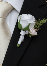 Artificial wedding boutonniere worn on a lapel, with a white faux rose, pale blush rosebud and green foliage. For formals, proms and ball occasions. Made in Melbourne by Flowers For Ever After, shipping Australia and Worldwide.