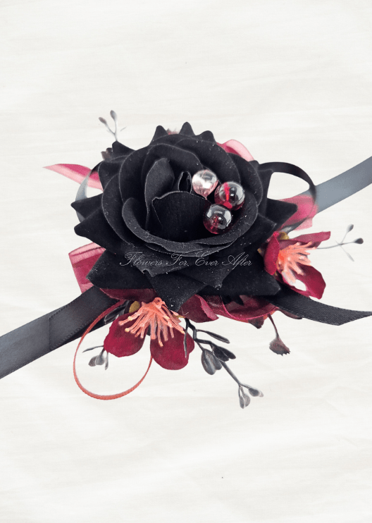 Artificial wedding wrist corsage with a black faux rose, burgundy blossoms, three clear jewel accents and black and burgundy ribbons. For formals, proms and ball occasions. Made in Melbourne by Flowers For Ever After, shipping Australia and Worldwide.