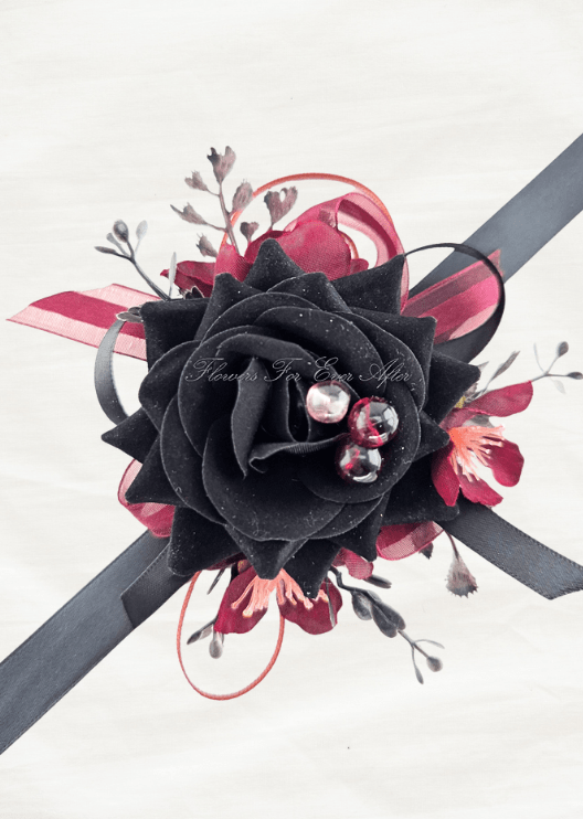 Artificial wedding wrist corsage, top view of a black faux rose with clear jewel accents, burgundy blossoms and ribbon loops. For formals, proms and ball occasions. Made in Melbourne by Flowers For Ever After, shipping Australia and Worldwide.