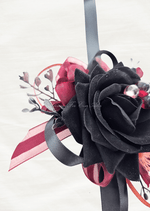 Artificial wedding corsage ribbon detail showing black and burgundy loops beside a black faux rose and dark sprigs. For formals, proms and ball occasions. Made in Melbourne by Flowers For Ever After, shipping Australia and Worldwide.