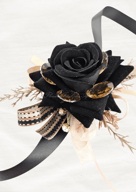 Artificial wedding wrist corsage with a black faux rose, amber jewel accents, golden sprigs and black and gold ribbon loops. For formals, proms and ball occasions. Made in Melbourne by Flowers For Ever After, shipping Australia and Worldwide.