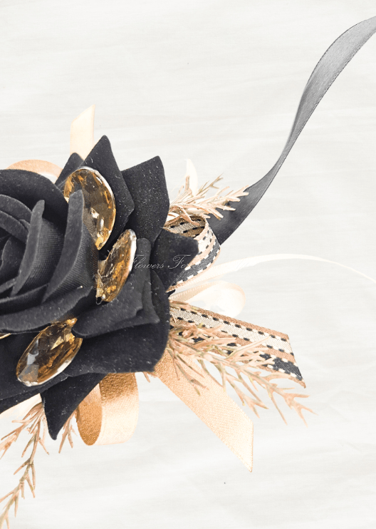 Artificial wedding corsage close-up showing a black faux rose, amber jewel accents, golden sprigs and patterned black and gold ribbons. For formals, proms and ball occasions. Made in Melbourne by Flowers For Ever After, shipping Australia and Worldwide.