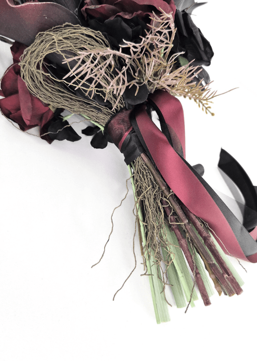 Artificial wedding bouquet handle detail with gathered faux flower stems, black and burgundy ribbons, fine bronze sprigs and dark blooms. Made in Melbourne by Flowers For Ever After, shipping Australia and Worldwide.