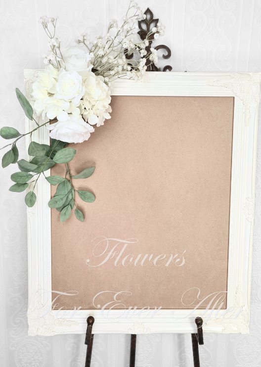 Artificial wedding sign decoration with white faux roses, clustered white blooms, delicate white sprigs and trailing eucalyptus at the upper corner. Made in Melbourne by Flowers For Ever After, shipping Australia and Worldwide.