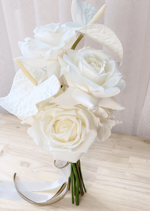 Artificial wedding bouquet close-up showing white faux anthuriums, roses and ranunculus above gathered stems. Made in Melbourne by Flowers For Ever After, shipping Australia and Worldwide.