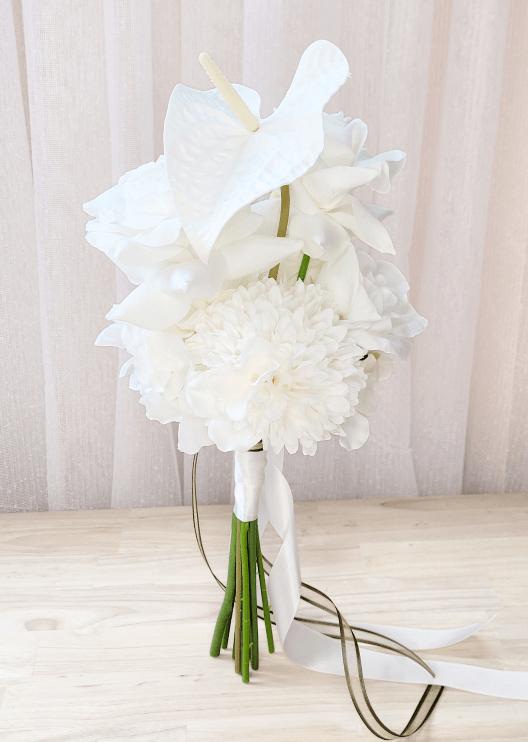 Artificial wedding bridesmaid bouquet with white faux anthurium, dahlia and roses, white wrapping and long ribbon tails. Made in Melbourne by Flowers For Ever After, shipping Australia and Worldwide.