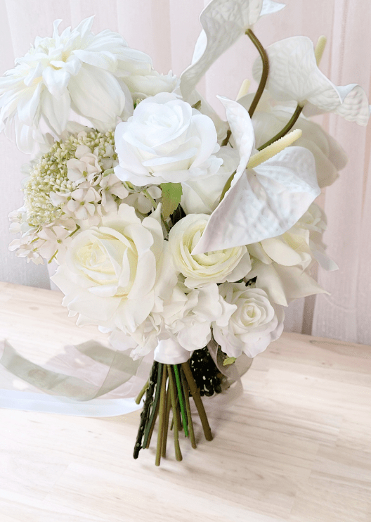 Artificial wedding bouquet close-up with white faux roses, ranunculus, anthuriums and cream flower clusters. Made in Melbourne by Flowers For Ever After, shipping Australia and Worldwide.