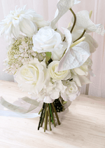 Artificial wedding bouquet close-up with white faux roses, ranunculus, anthuriums and cream flower clusters. Made in Melbourne by Flowers For Ever After, shipping Australia and Worldwide.