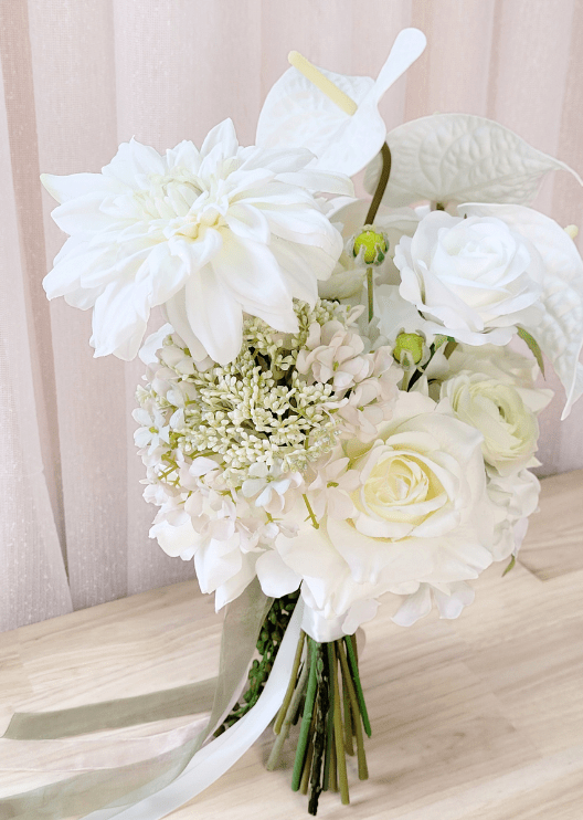 Artificial wedding bouquet detail showing white faux dahlia, anthurium, ranunculus and cream flower clusters. Made in Melbourne by Flowers For Ever After, shipping Australia and Worldwide.