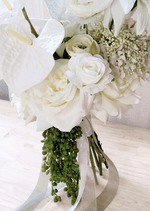 Artificial wedding bouquet detail showing white faux roses, ranunculus, anthurium and trailing green berries beside white and grey ribbons. Made in Melbourne by Flowers For Ever After, shipping Australia and Worldwide.