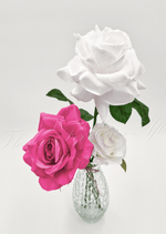 Artificial wedding table arrangement, angled view of faux roses and green leaves in a glass bottle. Made in Melbourne by Flowers For Ever After, shipping Australia and Worldwide.