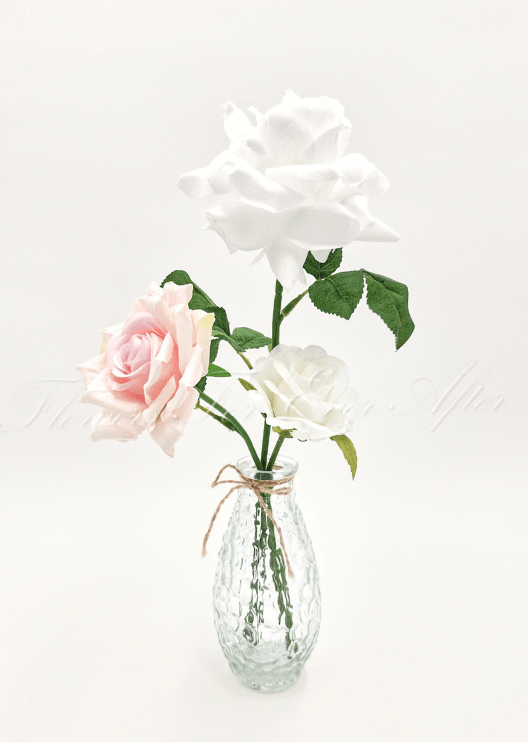 Artificial wedding table arrangement with small faux flowers and green sprigs in a glass jar. Made in Melbourne by Flowers For Ever After, shipping Australia and Worldwide.