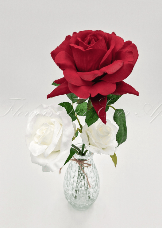 Artificial wedding table arrangement, angled view of small faux blooms and green leaves in a glass jar. Made in Melbourne by Flowers For Ever After, shipping Australia and Worldwide.