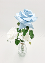 Artificial wedding table arrangement, angled view of faux roses and greenery in a glass bottle. Made in Melbourne by Flowers For Ever After, shipping Australia and Worldwide.