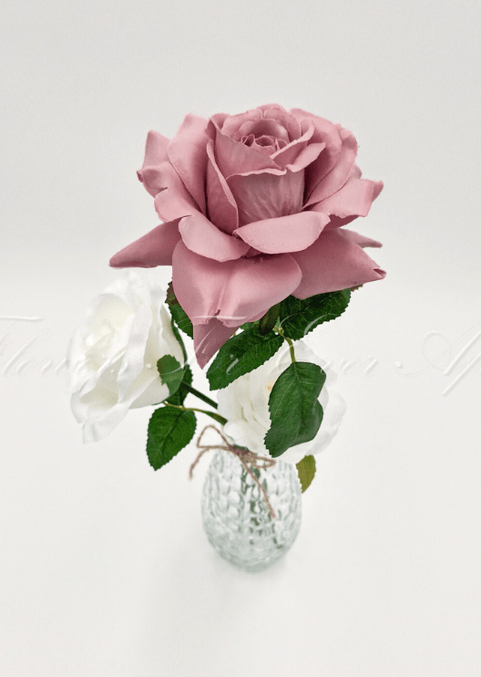 Artificial wedding table arrangement, overhead view of faux roses and green leaves in a glass bottle. Made in Melbourne by Flowers For Ever After, shipping Australia and Worldwide.
