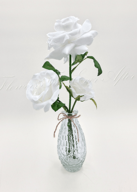 Artificial wedding table flower display with faux roses, smaller flowers and green leaves arranged in glass containers. Made in Melbourne by Flowers For Ever After, shipping Australia and Worldwide.