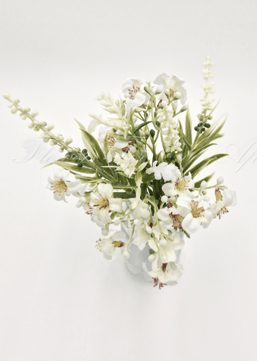 Artificial wedding table arrangement, overhead view of cream faux flowers and narrow green leaves in a clear jar. Made in Melbourne by Flowers For Ever After, shipping Australia and Worldwide.