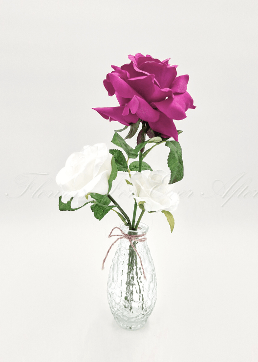 Artificial wedding table arrangement with small faux flowers and green sprigs in a clear glass jar. Made in Melbourne by Flowers For Ever After, shipping Australia and Worldwide.