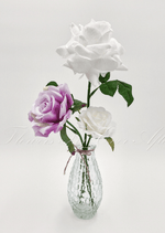 Artificial wedding table arrangement with faux roses and green foliage in a clear glass bottle. Made in Melbourne by Flowers For Ever After, shipping Australia and Worldwide.