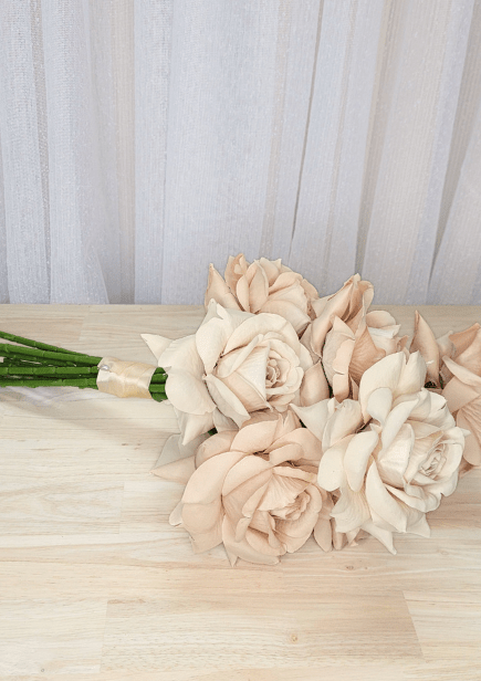 Artificial wedding bouquet laid sideways, showing beige-blush faux roses and ivory-wrapped stems. Made in Melbourne by Flowers For Ever After, shipping Australia and Worldwide.