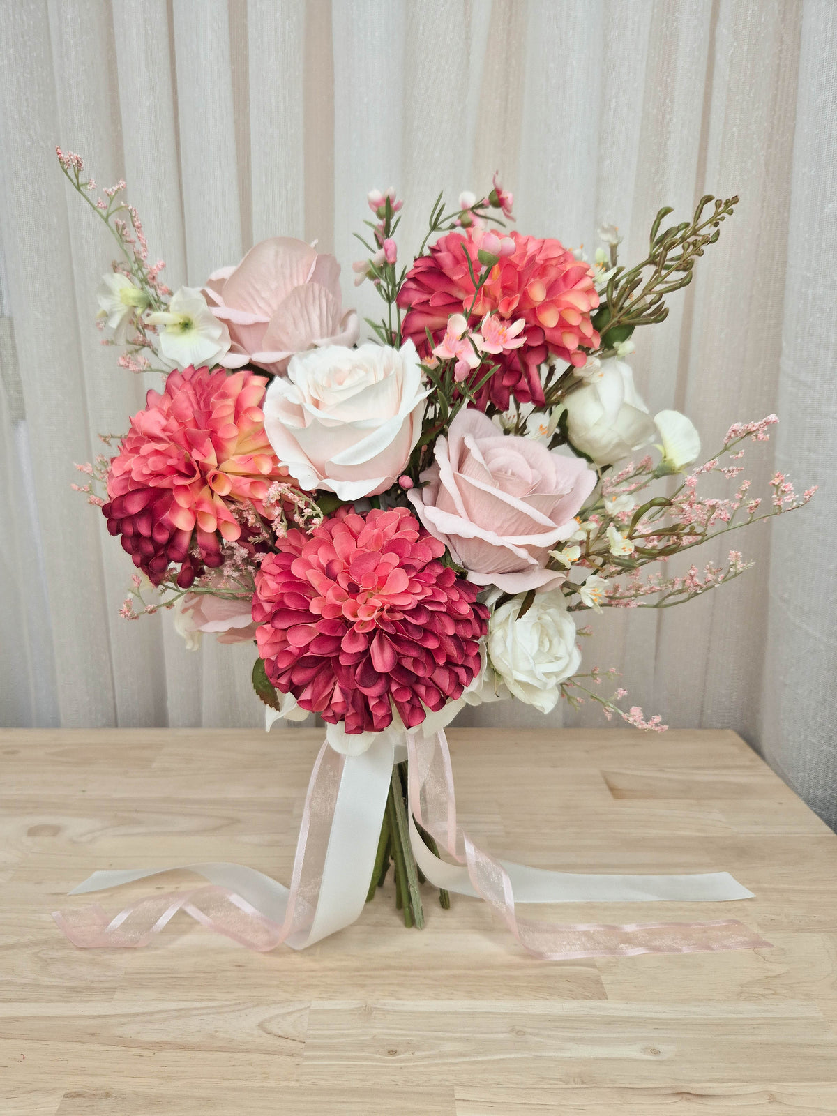 A faux flower bridal bouquet in different shades of pink and white.  Realistic vibrant dahlia, and soft blush pink roses.  Made in Melbourne Australia, by Australia's best online silk bridal florist