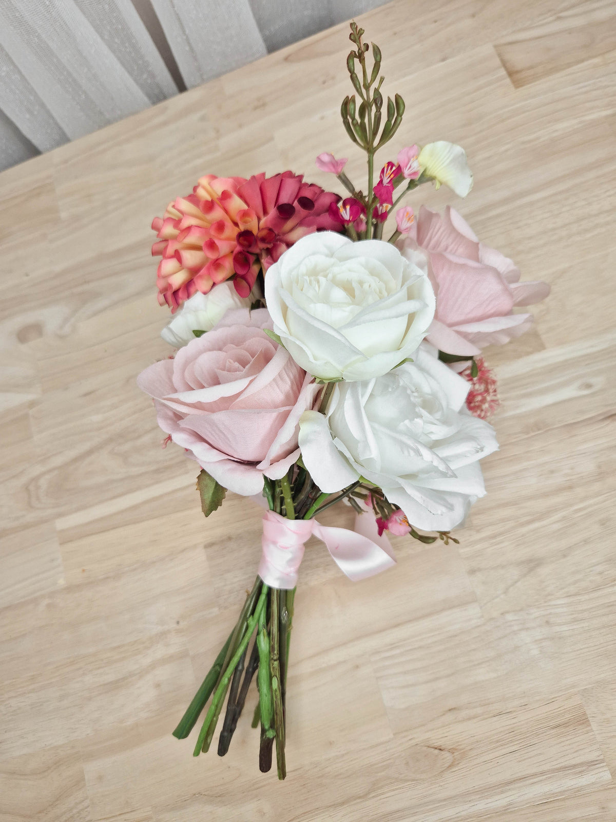 A faux flower bridesmaid bouquet in different shades of pink and white.  Realistic vibrant dahlia, and soft blush pink roses.  Made in Melbourne Australia, by Australia's best online silk bridal florist