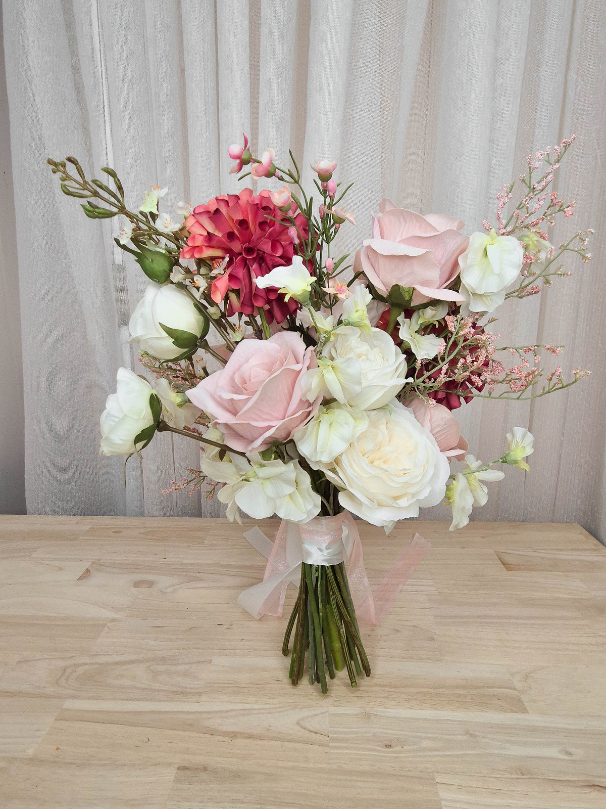 A faux flower bridal bouquet in different shades of pink and white.  Realistic vibrant dahlia, and soft blush pink roses.  Made in Melbourne Australia, by Australia's best online silk bridal florist