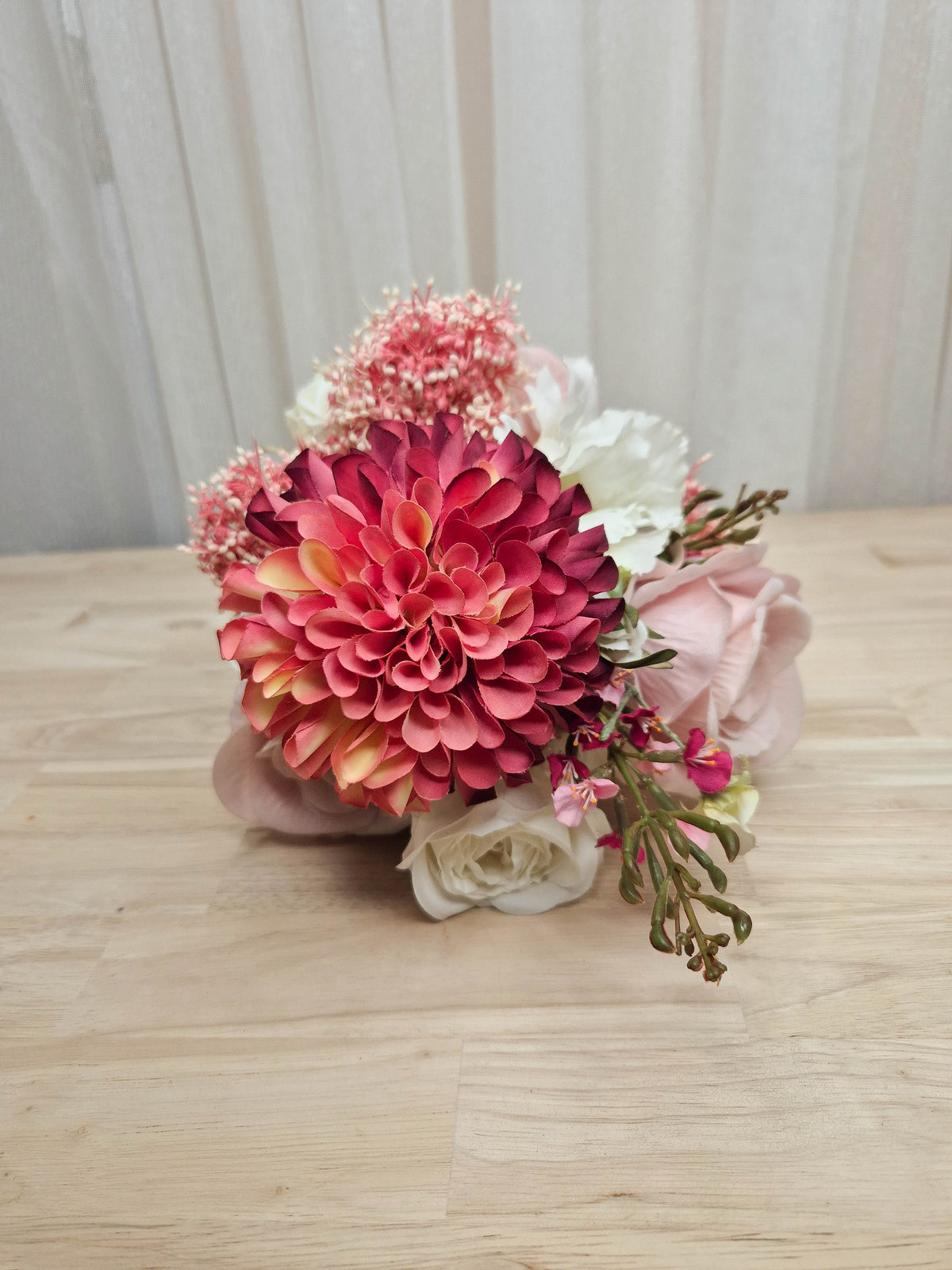 A faux flower bridesmaid bouquet in different shades of pink and white.  Realistic vibrant dahlia, and soft blush pink roses.  Made in Melbourne Australia, by Australia's best online silk bridal florist