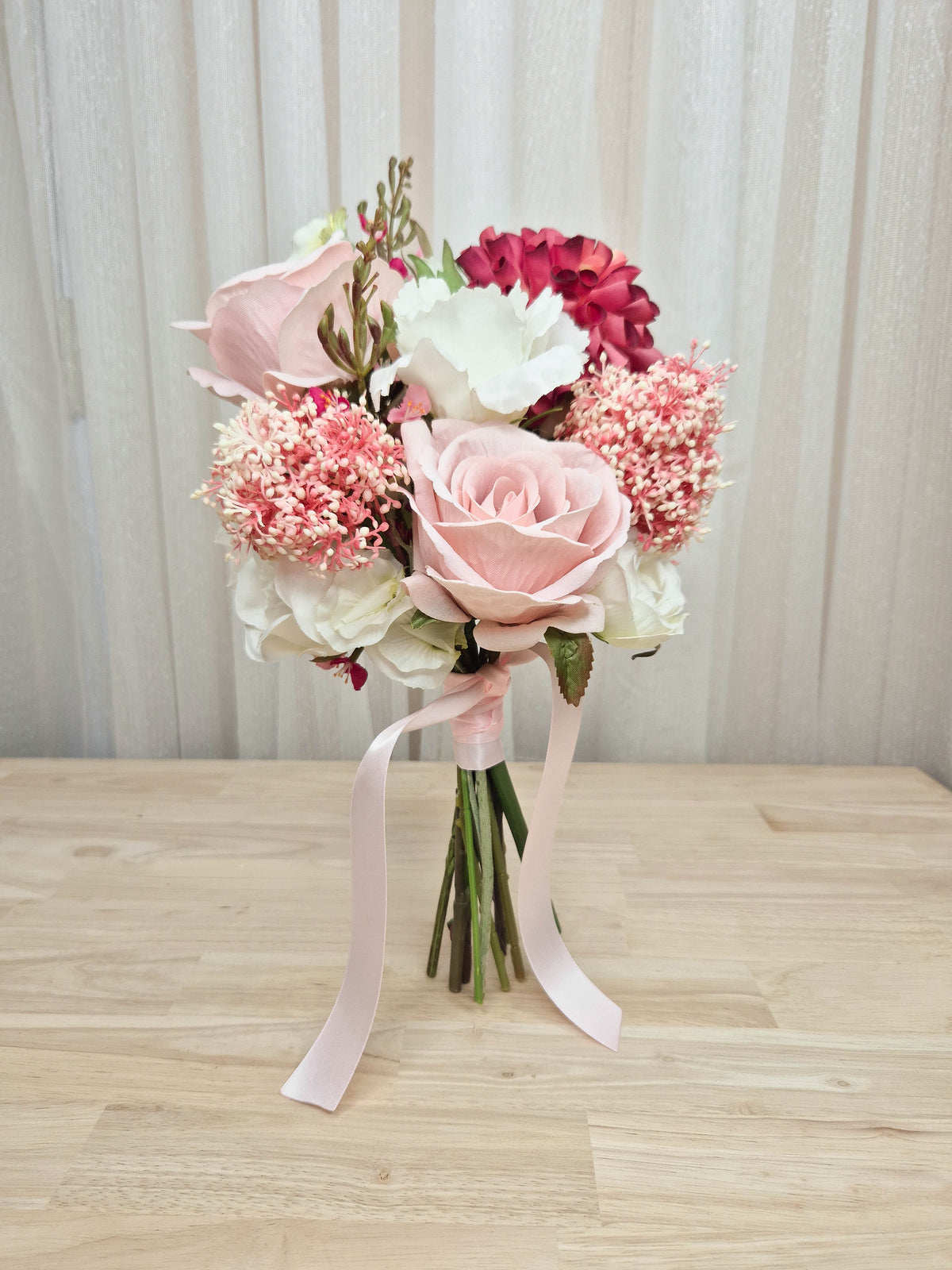 A faux flower bridesmaid bouquet in different shades of pink and white.  Realistic vibrant dahlia, and soft blush pink roses.  Made in Melbourne Australia, by Australia's best online silk bridal florist