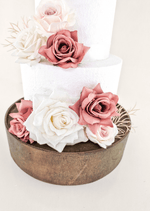 Artificial wedding cake decoration, angled view of dusty pink and white faux roses across the tiers. For birthday, event and celebration cakes. Made in Melbourne by Flowers For Ever After, shipping Australia and Worldwide.