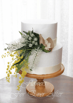 Artificial wedding cake decoration close-up with red faux bottlebrush, yellow wattle and grey-green foliage. For birthday, event and celebration cakes. Made in Melbourne by Flowers For Ever After, shipping Australia and Worldwide.